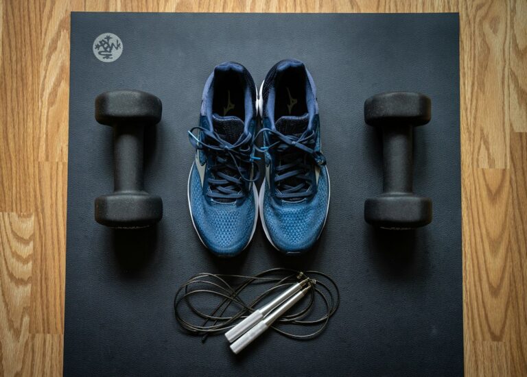Adult walking briskly outdoors while another person performs strength exercises at home.